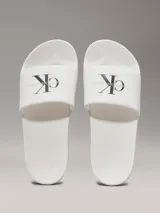 Ojotas blancas de Calvin Klein Jeans, con capellada de lona con logo estampado en negro.
