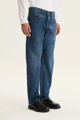 Pantalón de jean azul de corte recto, tiro medio y cierre con botones.