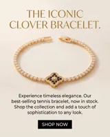 Pulsera de acero con baño dorado, compuesta por una cadena de circonias cúbicas y un dije central en forma de trébol decorado con circonias negras y blancas.