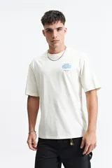 Remera de manga corta con calce oversize, confeccionada en algodón. Presenta un diseño estampado en la espalda con un gráfico abstracto y la palabra 'blurred'.