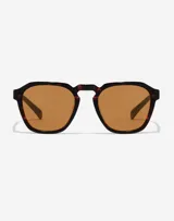 Lentes de sol Hawkers X Paula Echevarría, unisex, con montura geométrica color carey y lentes color marrón.