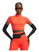 Top deportivo de entrenamiento Under Armour, modelo Vanish Elite, color naranja neón. Presenta un diseño cropped con cuello alto y cierre frontal parcial, mangas cortas raglán con paneles de malla para mayor ventilación y tejido elástico de secado rápido.