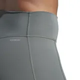 Calza deportiva larga Adidas Optime, color gris verdoso, de tiro alto y ajuste ceñido. Presenta un pequeño logo de Adidas en blanco en el muslo derecho y un bolsillo lateral.