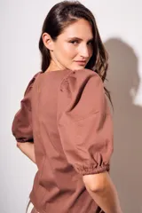 Remera color ladrillo de algodón peinado, de corte ajustado, con cuello redondo y mangas globo 3/4.