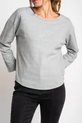 Sweater color crema de algodón peinado con cuello redondo y mangas largas.