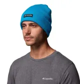 Gorro tipo beanie de punto acanalado en color azul brillante, con diseño de puño enrollado y parche rectangular con el logo de Columbia en el frente.