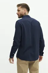 Camisa de manga larga color beige claro, confeccionada en una mezcla de lino y algodón. Presenta un corte semi slim, cuello camisero y un pequeño logo bordado en el pecho.