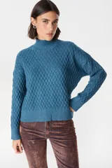 Sweater de tejido de punto con textura de panal, cuello alto y mangas largas con puños acanalados.