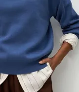 Buzo suéter de tricot con cuello redondo y puños ajustados, de diseño clásico y versátil.