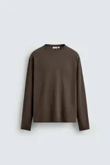 Camiseta de manga larga con corte relajado, confeccionada en tejido de algodón compacto. Presenta cuello redondo y detalle de costura vertical en el centro de la espalda.