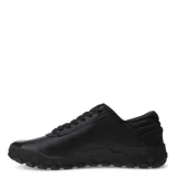 Zapatos Caterpillar modelo Hex + Cuero, color negro, estilo sneaker de caña baja con cordones. Presentan una capellada de cuero liso y textil, con suela de goma gruesa con patrón hexagonal en relieve. El logo Caterpillar en amarillo se encuentra en el lateral.
