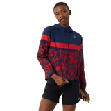 Campera deportiva New Balance con capucha, color azul marino con detalles en rojo y estampado con lunares blancos.