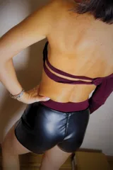 Body negro asimétrico de un solo hombro con manga larga, corte cavado y espalda descubierta.