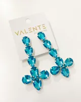 Aros colgantes con forma de flor, hechos con cristales facetados color turquesa y engarce plateado.