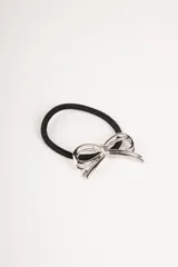 Gomita de pelo negra con adorno de moño plateado.