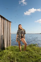 Camisa de corte oversize con estampado de palmeras, cuello clásico, manga corta y cierre frontal con botones de madera.