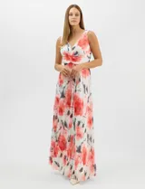 Vestido largo de chifón plisado con estampado floral en tonos rojos y grises sobre fondo blanco. Presenta escote en V pronunciado con panel de microtul, cintura drapeada con nudo central y falda amplia con capa frontal asimétrica. Incluye forro interior y cierre invisible en la espalda.