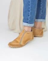 Zapato de cuero color beige con diseño de doble cierre frontal, puntera y talón reforzados en gamuza, y suela de goma con relieve.