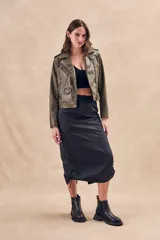 Falda midi negra estilo parachute, con cintura elástica, bolsillos laterales tipo cargo y cordones ajustables en el ruedo.