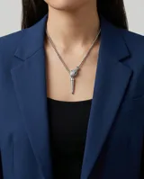 Collar de acero con cadena de eslabones tipo veneciana y colgante en forma de cabeza de serpiente con incrustaciones de circonias y ojos verdes, finalizado con un dije alargado en forma de punta.