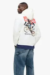 Canguro de corte holgado en color blanco, con capucha ajustable mediante cordones, bolsillo frontal tipo canguro y puños acanalados. Presenta un estampado gráfico en el pecho con la leyenda 'Apex Racing' y la silueta de un motociclista.