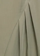 Vestido corto de diseño recto y sin mangas, con cuello barco y detalle de pliegues laterales en la falda. Cuenta con cierre de cremallera en la parte posterior y forro interior.