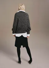 Jersey de punto jaspeado en tonos grises y negros, con cuello en V profundo, mangas largas y diseño recto holgado.