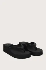 Sandalias negras con plataforma alta y tiras de dedo decoradas con abalorios y pedrería brillante.