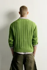 Sweater de punto canalé en hilatura de algodón, color verde, con cuello en V y manga larga.