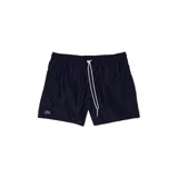 Short de baño Lacoste color azul marino, con cintura elástica y cordón de ajuste blanco. Presenta el logo de la marca bordado en la parte inferior izquierda.