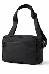 Bandolera color gris con cierre principal y bolsillo frontal con cierre. Cuenta con correa ajustable negra y hebillas de plástico.