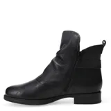 Botas de caña media marca Bottero, confeccionadas en cuero negro con interior forrado en corderito sintético color crema. Presentan una tira decorativa con hebilla lateral y suela plana con pequeño taco.