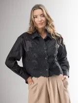 Camisa blanca de manga larga con bordado de encaje en el frente y mangas semi abullonadas.