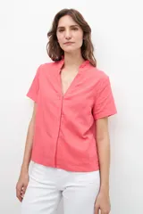 Blusa fucsia de lino con cuello mao y volados, corte recto y mangas cortas.
