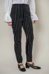 Pantalón negro de terciopelo con rayas verticales de lurex y cintura elástica.