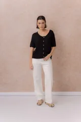 Jeans rectos blancos de tiro medio, con diseño clásico de cinco bolsillos, cierre de botón y bragueta, y perneras ligeramente amplias.