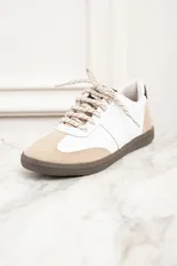 Zapatillas bajas de cuero blanco con puntera y talón en gamuza color beige. Ajuste con cordones y suela marrón.