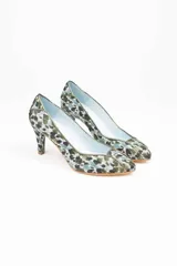 Zapatos de tacón estilo salón con diseño clásico, confeccionados en arpillera con estampado animal print en tonos verdes. Presentan ribetes de piel tornasolada que dividen las piezas de la puntera, laterales y talonera, con interior en piel y suela de cuero.