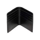 Billetera Marc Jacobs modelo The Billfold, de cuero texturizado color negro, con diseño plegable y el texto 'THE WALLET' impreso en la parte frontal junto con la marca.
