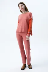 Jean acampanado color ladrillo, de tiro medio/alto, confeccionado en denim coteado.