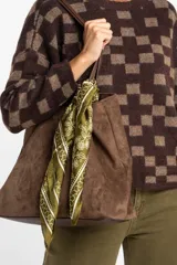 Bandana de tela ligera color verde pistacho con estampado floral y geométrico en blanco.