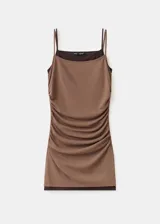 Vestido corto marrón con efecto de doble prenda, superpuesto sobre un fondo negro. Presenta tirantes finos y un diseño ajustado al cuerpo con fruncidos en los laterales.