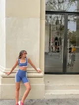 Calza corta de lycra negra con rayas verticales blancas y terminaciones en verde flúor.