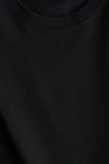 Remera de corte boxy en punto suave de algodón, con cuello redondo, hombros caídos y mangas cortas al codo.