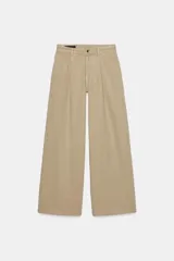 Jeans de tiro alto con pinzas delanteras, pernera ancha y fluida. Cuenta con cierre frontal de cremallera y botón, bolsillos frontales y bolsillos de plastrón en la parte trasera.