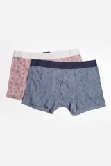 Pack de dos boxers para hombre, uno azul con estampado de dinosaurios y otro azul marino con estampado de símbolos.