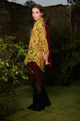 Pantalón de tiro medio color borgoña con elástico en la cintura y caída en evase similar a un oxford intervenido a mano en Uruguay con punto crochet en 100% algodón color negro. Talle único.