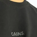 Buzo de cuello redondo, manga larga y corte holgado, confeccionado en tejido de algodón y poliéster. Presenta un diseño minimalista con la palabra 'GAINS.' bordada en el centro del pecho.