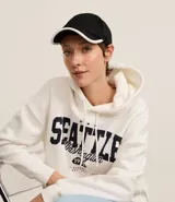 Gorra negra de sarga con visera curva y borde contrastante en blanco.