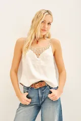 Top tipo musculosa de modal satén color crema, con detalle de encaje calado y bordados a tono en el escote delantero y en la espalda.